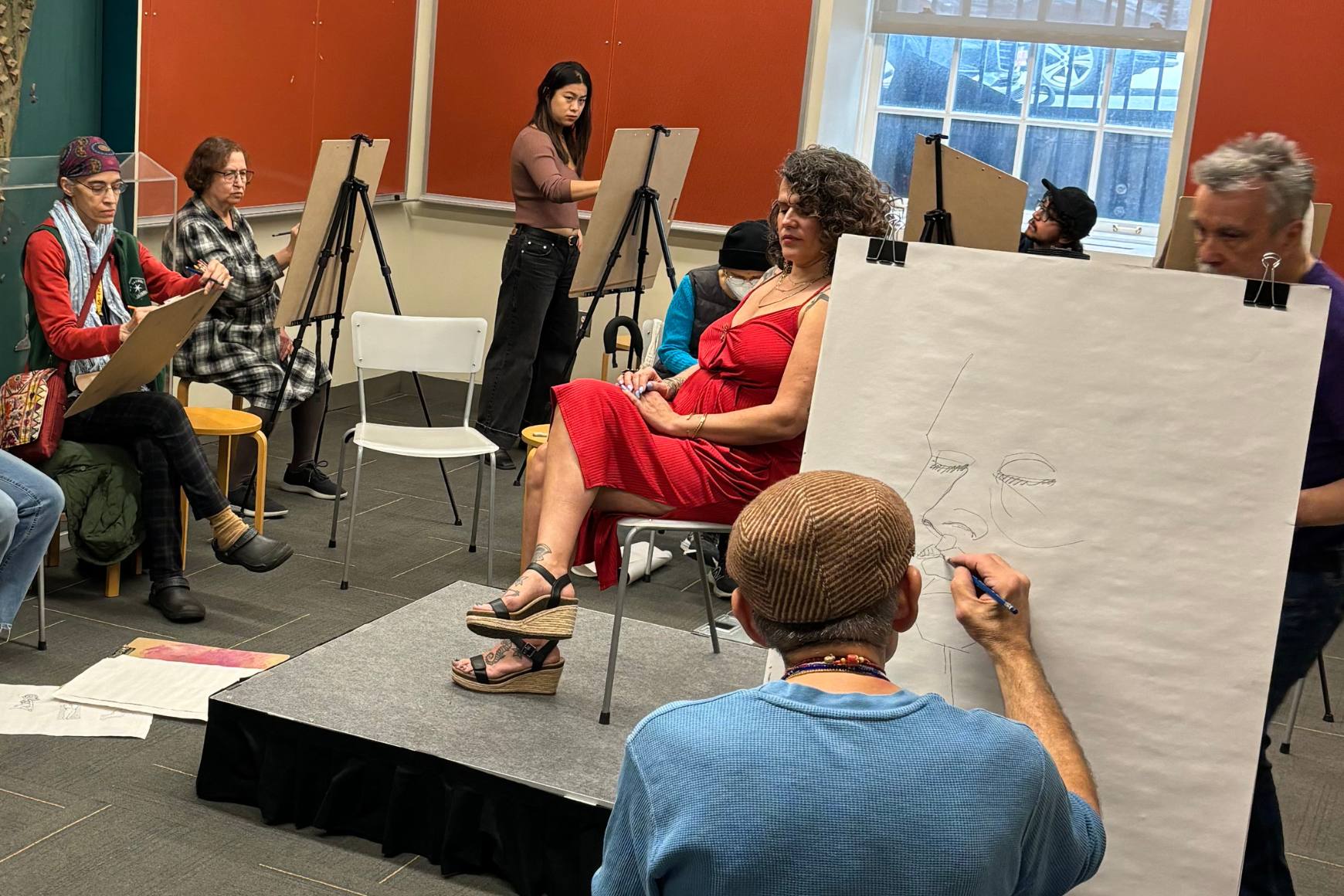 Maricruz Badia-Cestero poses as Manny Vega and guests draw her.